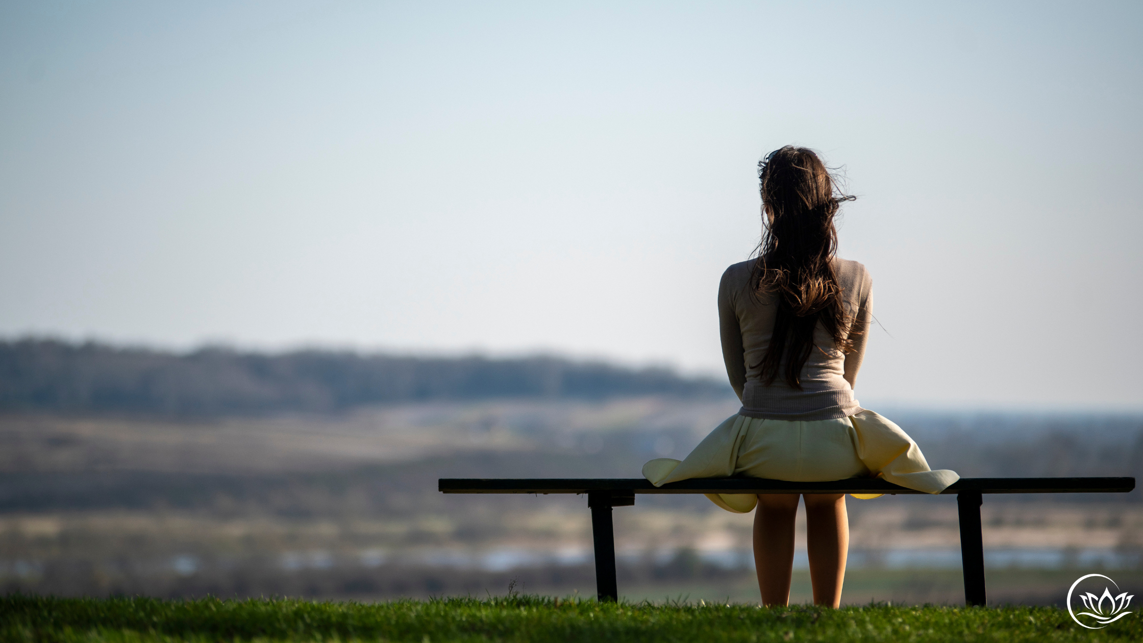 Woman sitting peacefully outdoors after recovering from chronic stress and menopause burnout